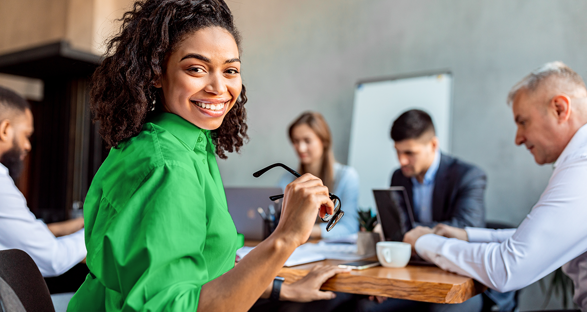 diverse woman smiling and in a work meeting