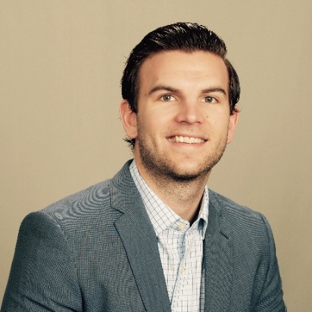 Smiling man in a blue blazer and checked shirt poses confidently—perfect for business lending promotions.