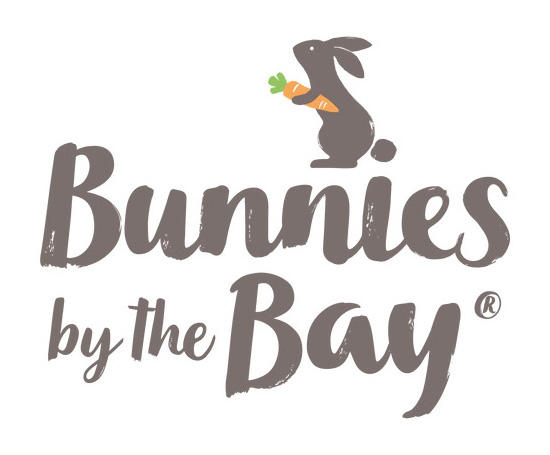 Bunny holding a carrot above the text "Bunnies by the Bay" in a playful handwritten font.