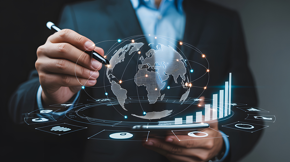 A person in a suit interacts with a digital globe and data charts on a virtual screen.