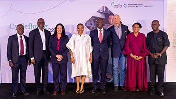 Nine people stand side by side on stage at a CycleFlow Supply Chain Finance event with a branded backdrop.