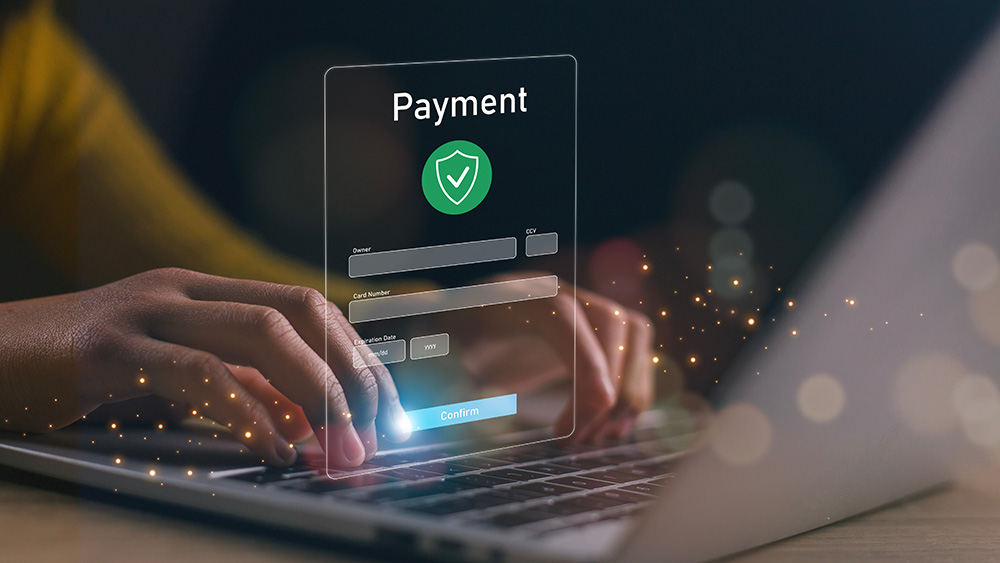Hands typing on laptop with digital payment confirmation overlay, glowing effects, and C2FO Preferred branding.